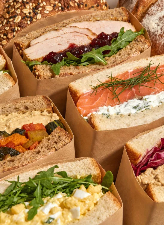 Gourmet sandwiches packed in paper boxes, seen from above