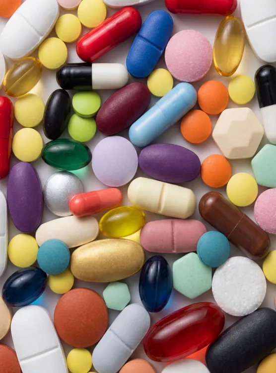 Colorful pills and capsules scattered edge to edge