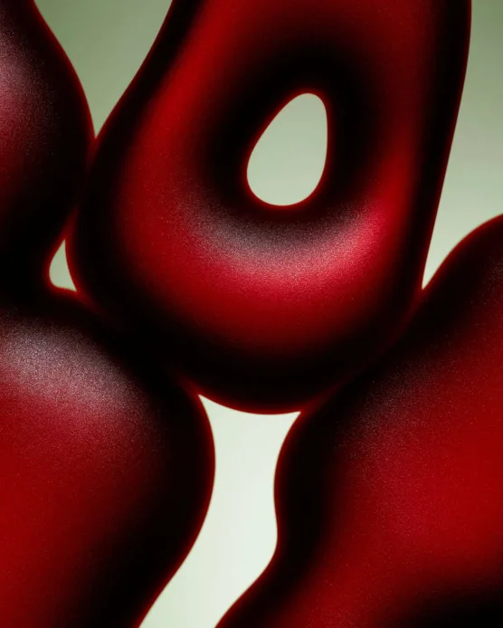 Abstract glossy dark red curves, sculptural macro